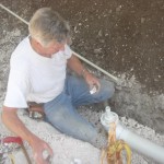 Bill working on drain for washer