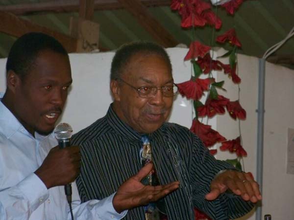 Pastor Lewis and Simon preaching