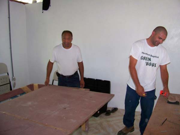 Pastor Lewis and Paul working on dining tables