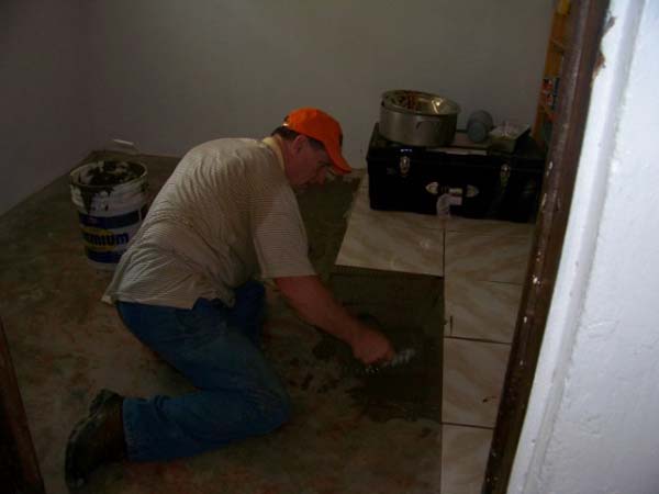 Pastor Bruce laying tile