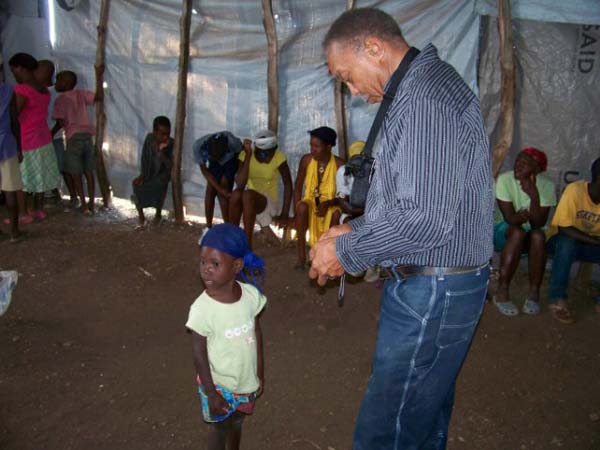 Pastor Lewis with little girl in clinic