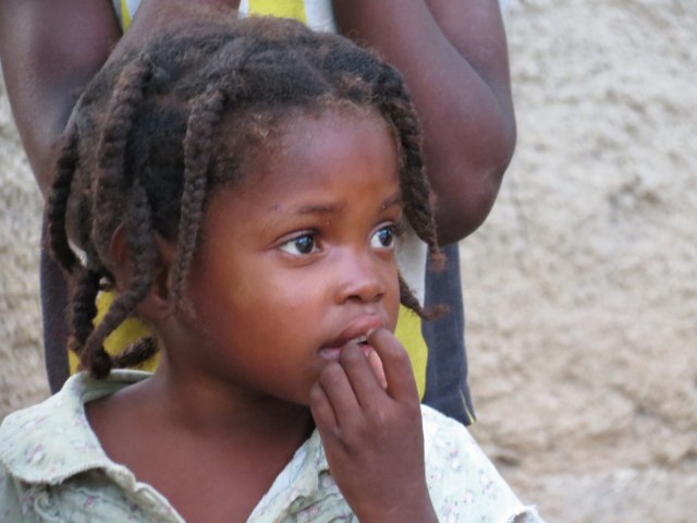 Little girl watching Jesus film in voodoo village