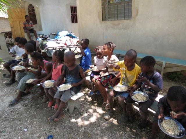 Children eating food from Feed My Straving Children/ Love A Child