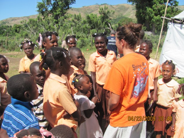 Hilary loving on the Haitian children