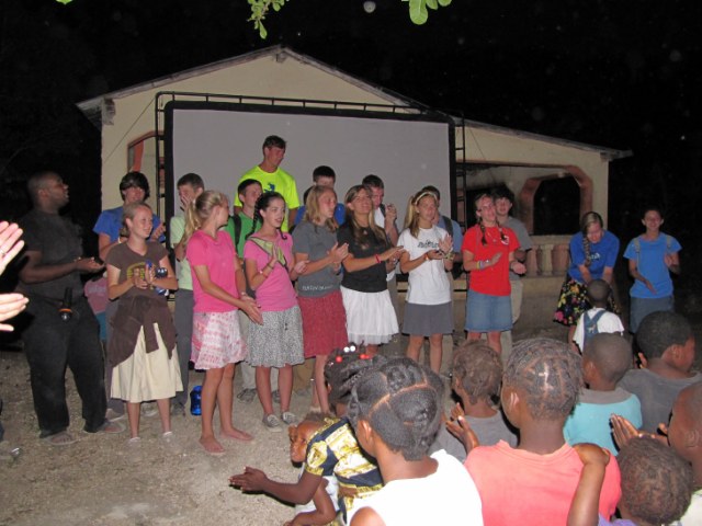 Team singing in Daniel's voodoo village